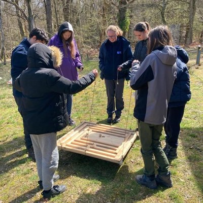 The group takes part in a team building exercise