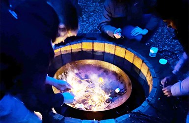 Enjoying a cup of hot chocolate round the camp fire
